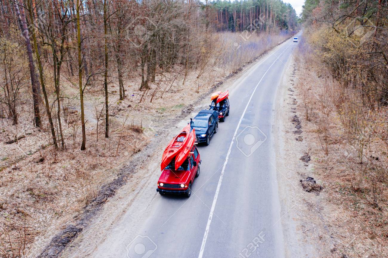 http://outdoorshuttle.com/wp-content/uploads/2020/02/121959280-several-cars-with-kayaks-on-roof-rack-driving-on-the-road-among-trees.jpg